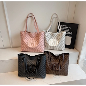 Collection of four large tote bags featuring embossed M logo and vintage print in various colors