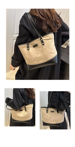 Detail view of khaki canvas tote bag featuring diamond quilt stitching and black leather trim