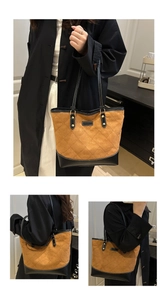 Detail of camel suede tote bag with diamond stitching and black leather trim accents