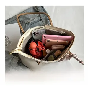 Interior view of large capacity tote bag showing umbrella, tablet, and wallet storage