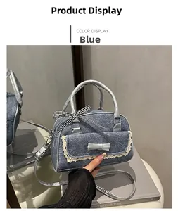 Detail of blue denim bowling bag with white lace trim and grey ribbon bow decoration