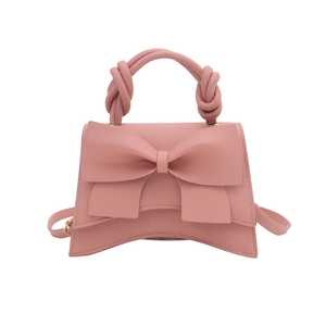 Pink minimalist handbag with oversized bow detail and twisted handle for women