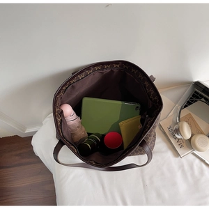 Top view of large brown tote bag interior filled with daily essentials for storage detail