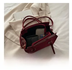 Spacious interior of burgundy leather handbag showing compartments for phone and wallet