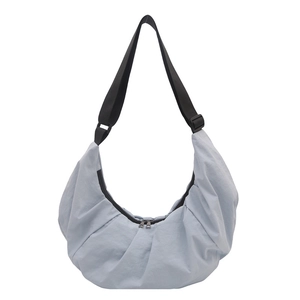 Light blue minimalist dumpling shoulder bag with adjustable strap and zip closure