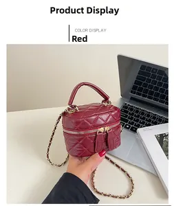 Detail of red quilted leather mini bag with gold-tone hardware and chain strap
