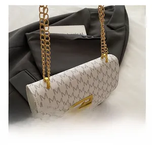 Close-up of white leather monogram shoulder bag with gold chain and square buckle