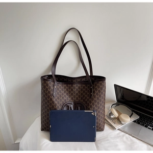 Large capacity tote bag with M-letter print shown with a laptop for size comparison