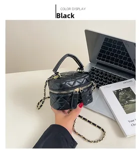 Detail of black quilted leather box bag featuring gold chain and double zipper closure
