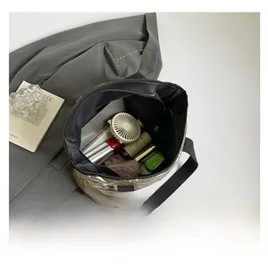 Interior view showing the large capacity of a gold quilted tote bag with various accessories