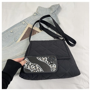 Quilted nylon crossbody bag shown with a smartphone for size comparison and capacity