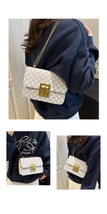 Close-up of white printed crossbody bag with golden chain and metallic rectangle clasp