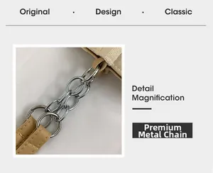 Detail of silver dual-row hardware chain and light brown leather strap on tote bag