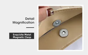 Detail view of the silver magnetic buckle on a beige plaid tote bag with clean stitching