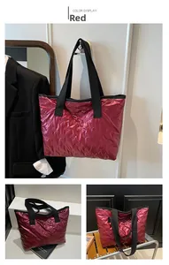Detailed close-up of a red puffy tote bag featuring unique butterfly embossed patterns