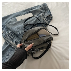 Top view of grey vintage crossbody bag with bow detail showing interior storage capacity