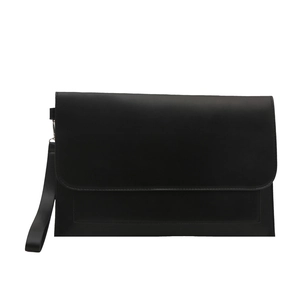 Minimalist black leather messenger bag with flap cover and detachable wrist strap