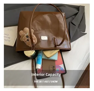 Brown gloss tote bag interior showing capacity for tablet, phone and cosmetics