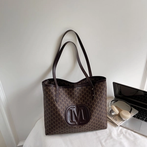 Brown tote bag with all-over M-pattern and embossed logo for daily commuting
