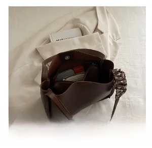 Internal view of the dark brown leather tote bag with zip pocket and silk twilly detail