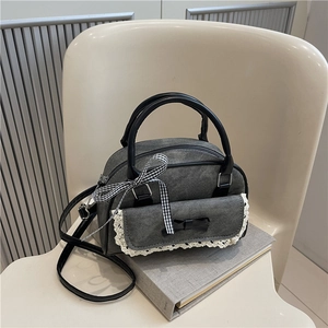 Chic grey denim crossbody pillow bag with black bow and lace trim details