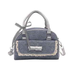 Gray denim Boston bag with lace trim and silver bow detail for a trendy style
