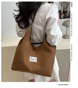 Macro detail of brown frosted suede tote bag with stylish white fashion logo label