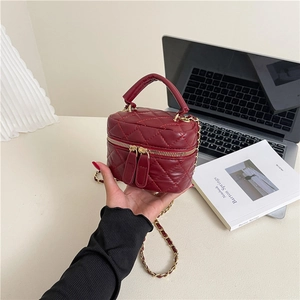 Quilted burgundy leather mini crossbody box bag with gold chain strap and top handle