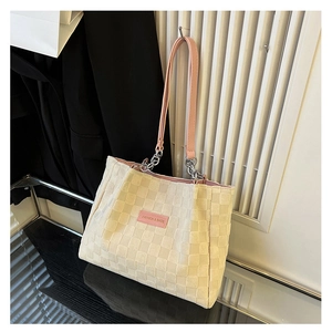 Detail of checkered tote bag with pink straps and silver chain metal connectors