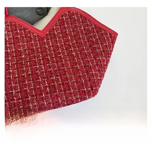 Close-up of red and gold woven tweed fabric with V-shaped top opening on tote bag