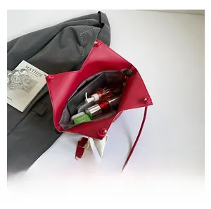 Interior view of red leather tote bag showing large capacity for tablet and cosmetics