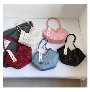 Macro shot of stylish tweed tote bags in five colors with silk scarf and logo tag