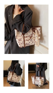 Detail of canvas tote bag with brown leather handles and cute bunny plush charm