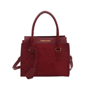 Burgundy woven texture tote bag with gold hardware and top handle for elegant daily use