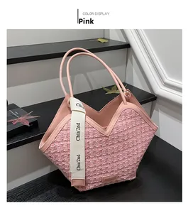 Detail of pink tweed tote bag featuring V-cut edge and branded wide decorative ribbon