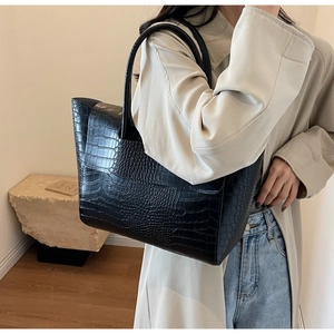 Dettaglio della trama a coccodrillo nera su una grande borsa tote in pelle da donna