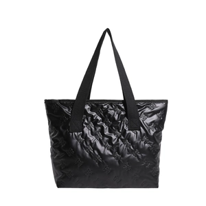 Minimalist black tote bag with embossed bow patterns and wide webbed handles