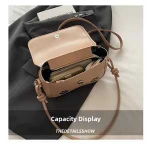 Detail shot of cute cat paw crossbody bag interior showing spacious storage for daily items