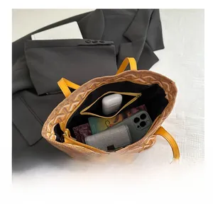 Internal view of a tote bag showing spacious capacity with a yellow zipper pocket