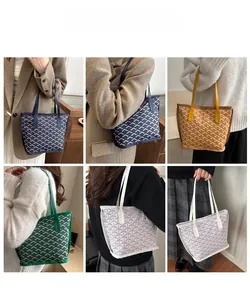 Detailed close-up showing classic chevron pattern and durable leather handles on tote bag