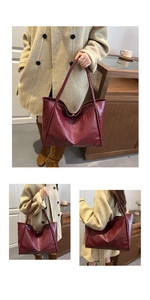 Detail view of burgundy faux crocodile tote bag styled with autumn workwear coat