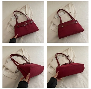 Detail view of burgundy suede underarm bag showing front, side, and bottom textures