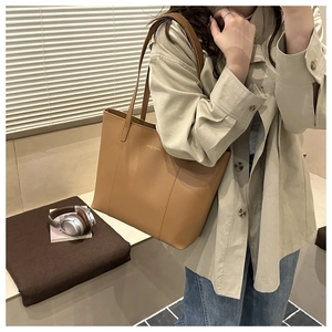 Brown large capacity tote bag shown on model for stylish daily commuting usage
