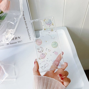 Close-up of clear phone case with pink glitter planets and stars for Samsung S25 Ultra