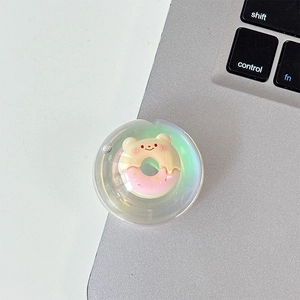 Macro detail of iridescent transparent phone grip with cute donut bear design inside
