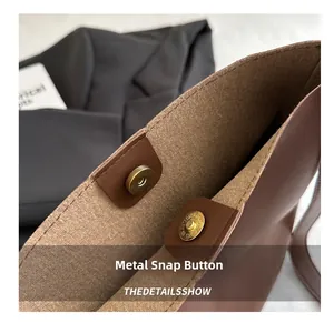 Detail of the high-quality magnetic closure and stitching on the brown leather tote