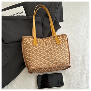 Top-down view of yellow tote bag featuring Y-shaped pattern with a phone for scale
