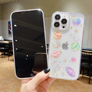 Detail of transparent glitter phone case with starry sky and planet patterns