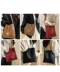Detailed views of leather bucket bag in brown, red and black with gold rivets