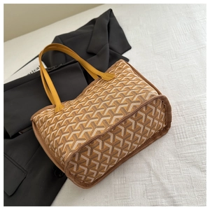 Macro view of chevron pattern on tote bag with vibrant yellow leather handles
